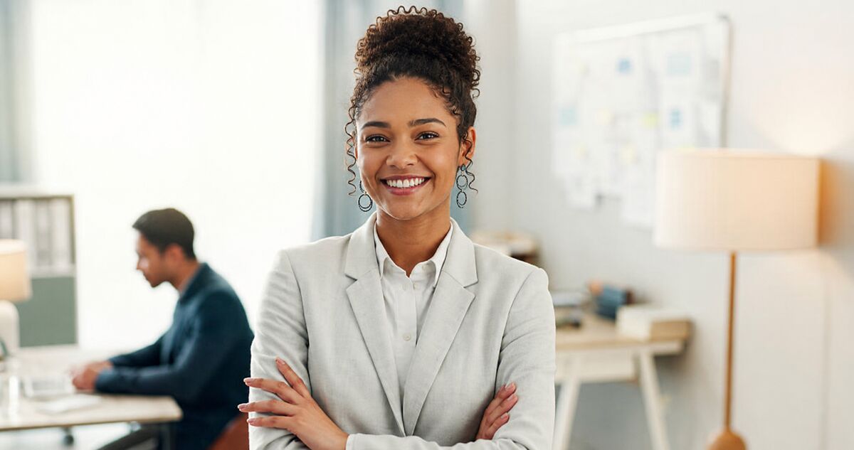 A confident South African businesswoman standing in a modern open-plan office