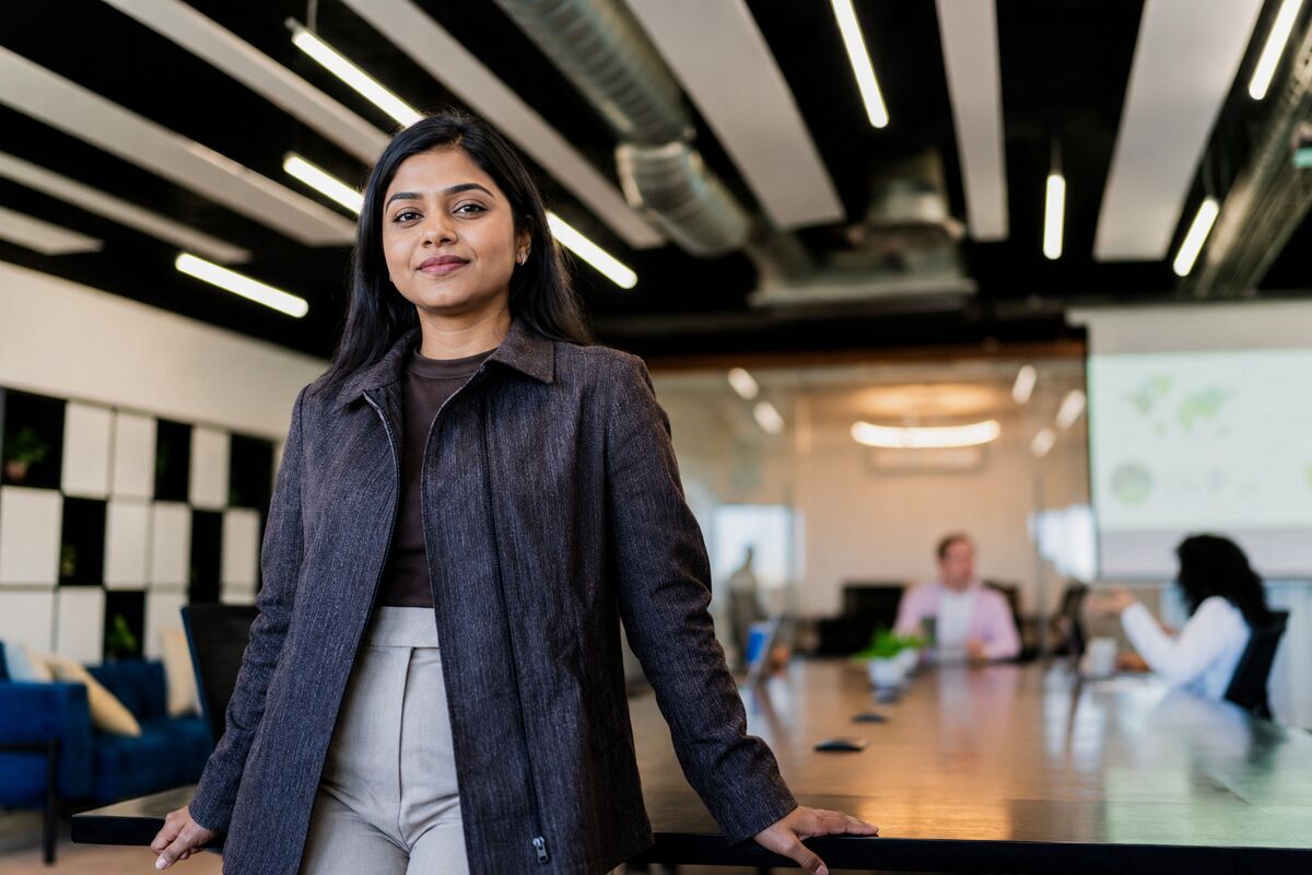 A business leader standing in a corporate meeting room
